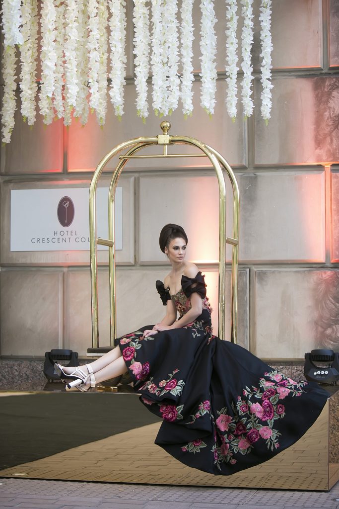 A model poses in front of Hotel Crescent Court