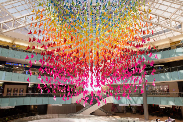 Over 4,000 handmade paper origami's of all color hang in Galleria Dallas' Center Court