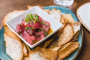 Share a plate of Ahi Tuna Poke or even Bacon Cheddar Tots at Public School