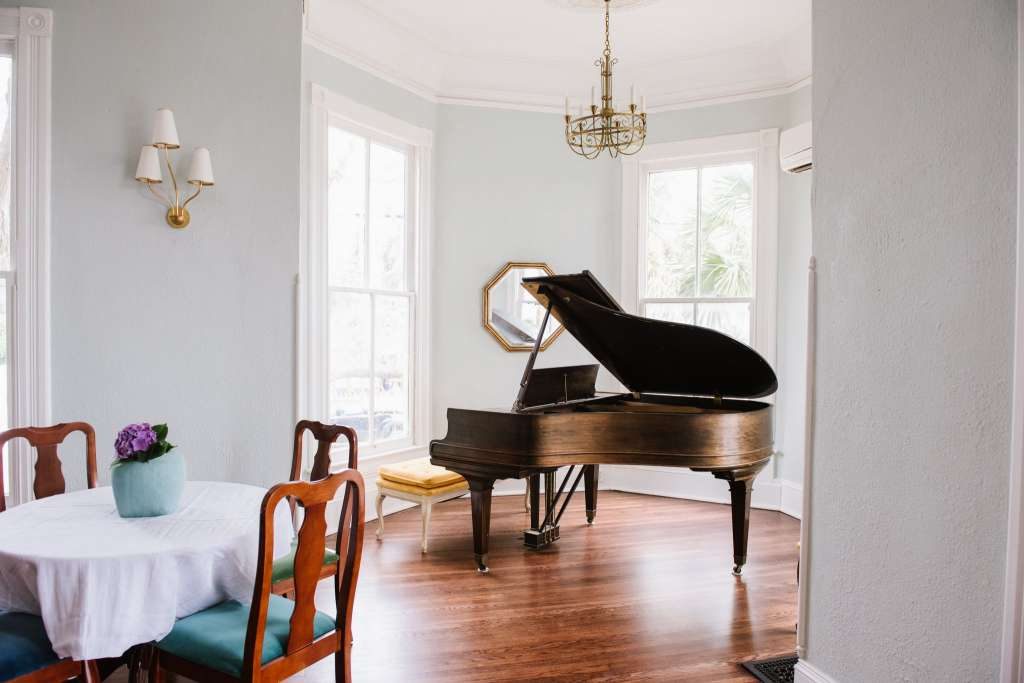The vintage grand piano is a nod to the home's rich past. 