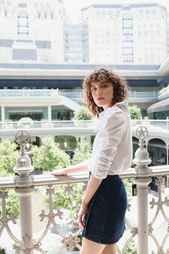 Dress up a denim skirt with a frilly blouse.