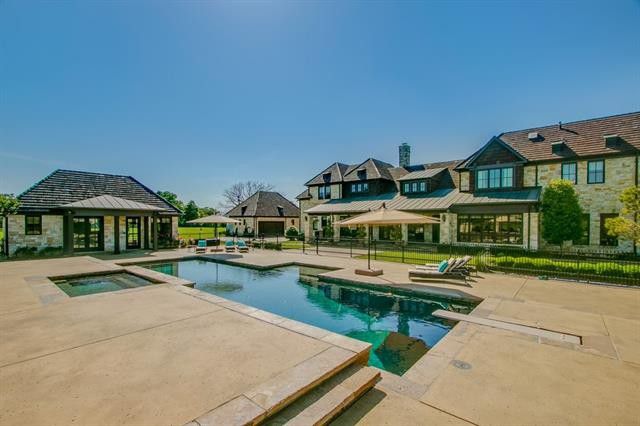 A sparkling pool and spa add to the curb appeal. 