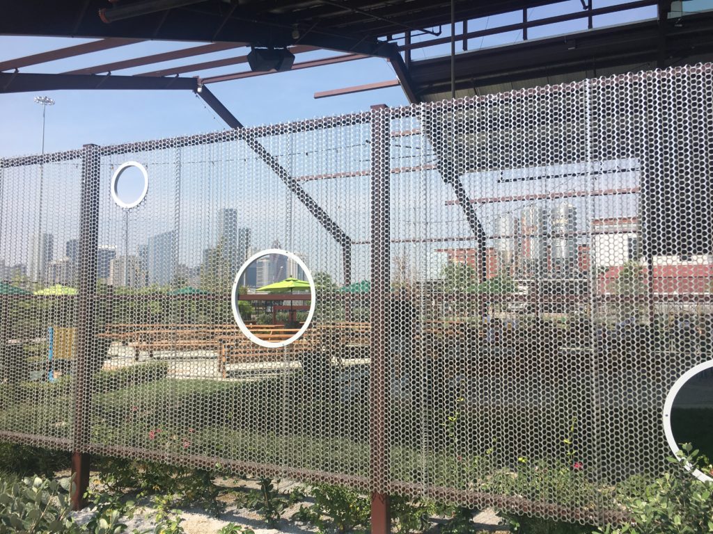 The dissolving building ties into the industrial surroundings. 