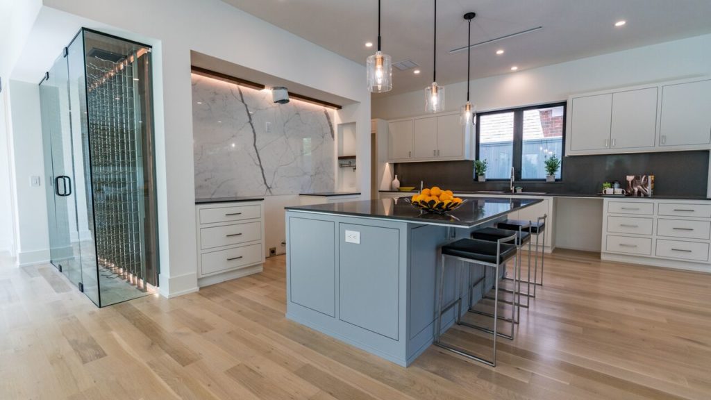 A marble accent wall makes the kitchen chic.