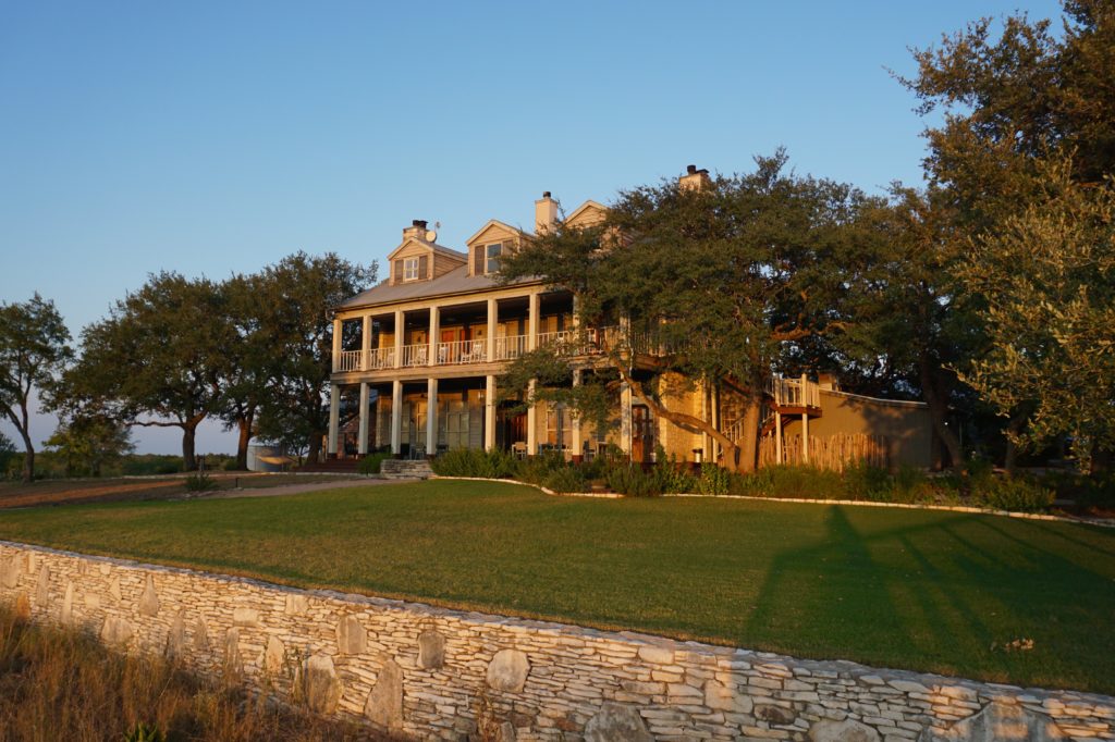 The back of the main farmhouse leads to the pool, fire pit, and hiking trails. 