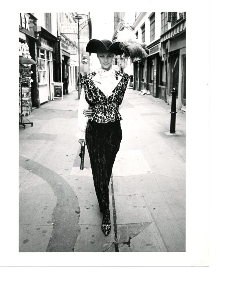 Here's a Jan Strimple street shot with a gun and feathered hat.