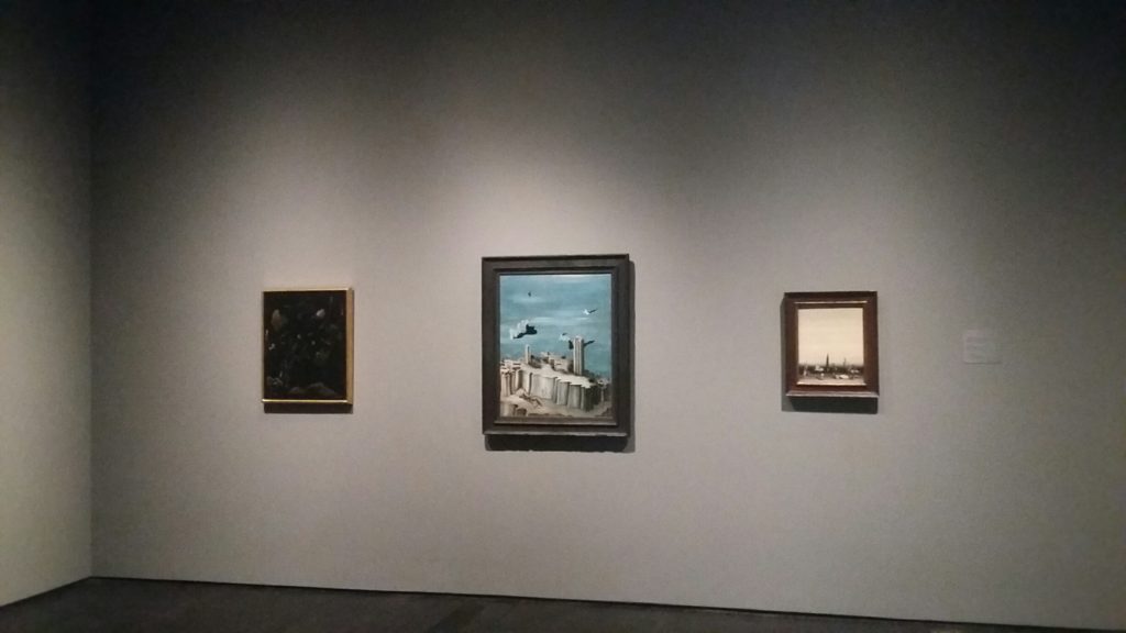 A wall of Yves Tanguy canvases face off with nearby works by Picasso.