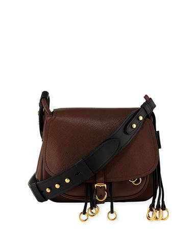 <a href=“http://www.thelittlebirdinc.com/collections/handbags/products/prada-city-saddle-crossbody-bag”>Prada City Saddle Crossbody Bag, $1,495.</a>