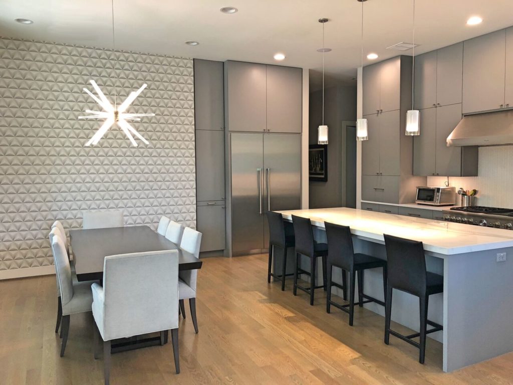 Gold hardware accents and gray flat custom cabinets complement the kitchen's countertops at 5138 Glenmeadow. 