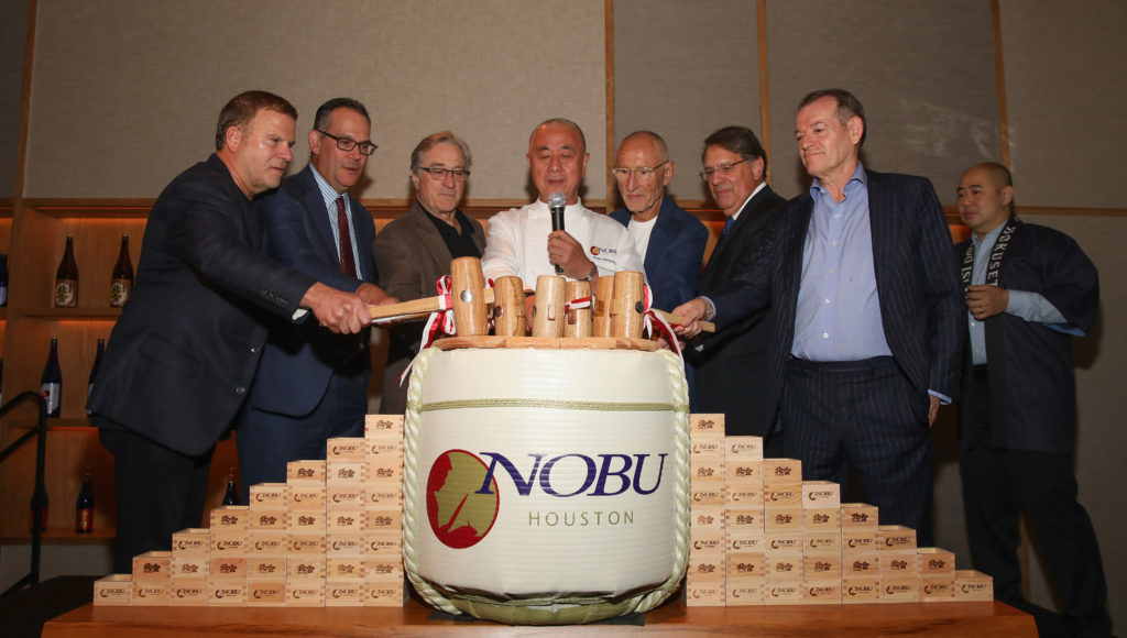 HOUSTON, TX - OCTOBER 18:  Nobu Founders Robert De Niro, Chef Nobu Matsuhisa, Meir Teper and friends break open a 5-gallon sake barrel at the Nobu Houston Sake Ceremony on October 18, 2018 in Houston, Texas.  (Photo by Rick Kern/Getty Images for Nobu)