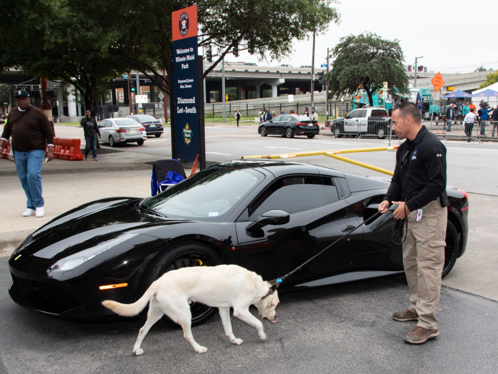 Chris Paul's Ferrari gets the once over from the police dogs. Does he smell a future championship?(Photo by F. Carter Smith.)