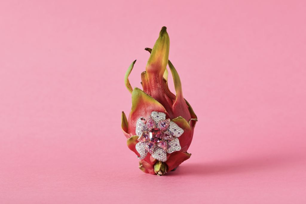 Orchid brooch with rare pink spinel center surrounded by multi coloured sapphire and diamonds in 18 karat white gold