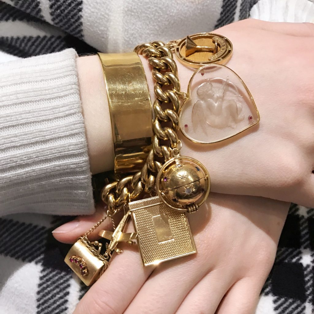 A charm bracelet paired with a bangle from a personal collection 