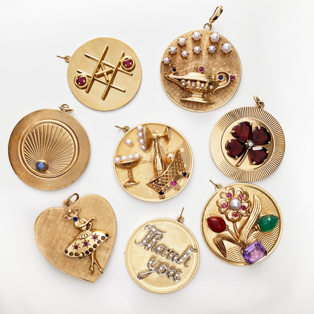 A group of mid-Century oversized disc charms