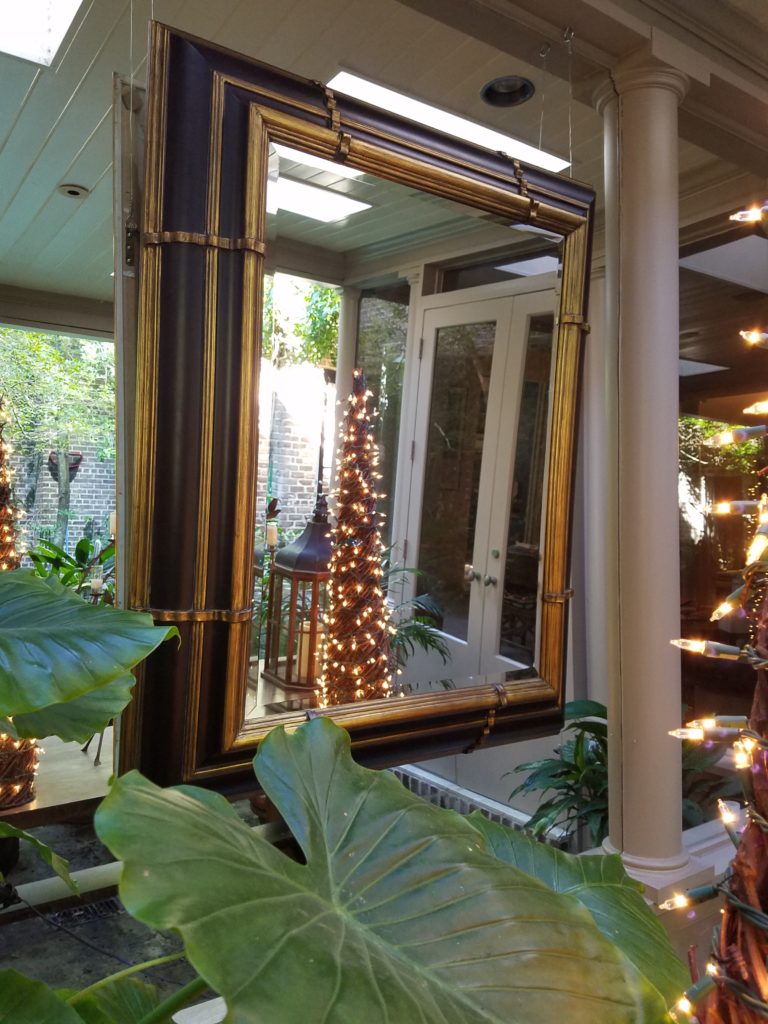 A mirror hangs outside, atop a wall of mirrors at the stately Upper Kirby townhome of Munson Mirrors founder Carol Isaak Barden. Photo courtesy Carol Isaak Barden.