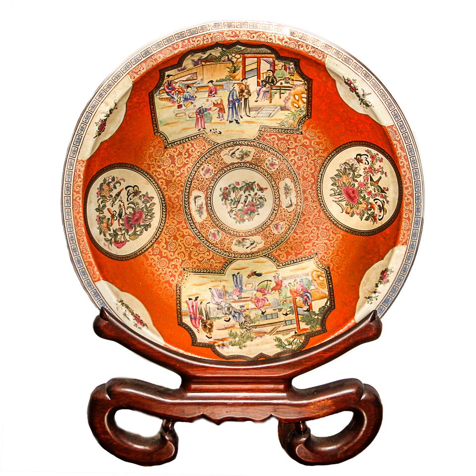 This large decorative Chinese plate boasts two village scenes and floral motifs. 
