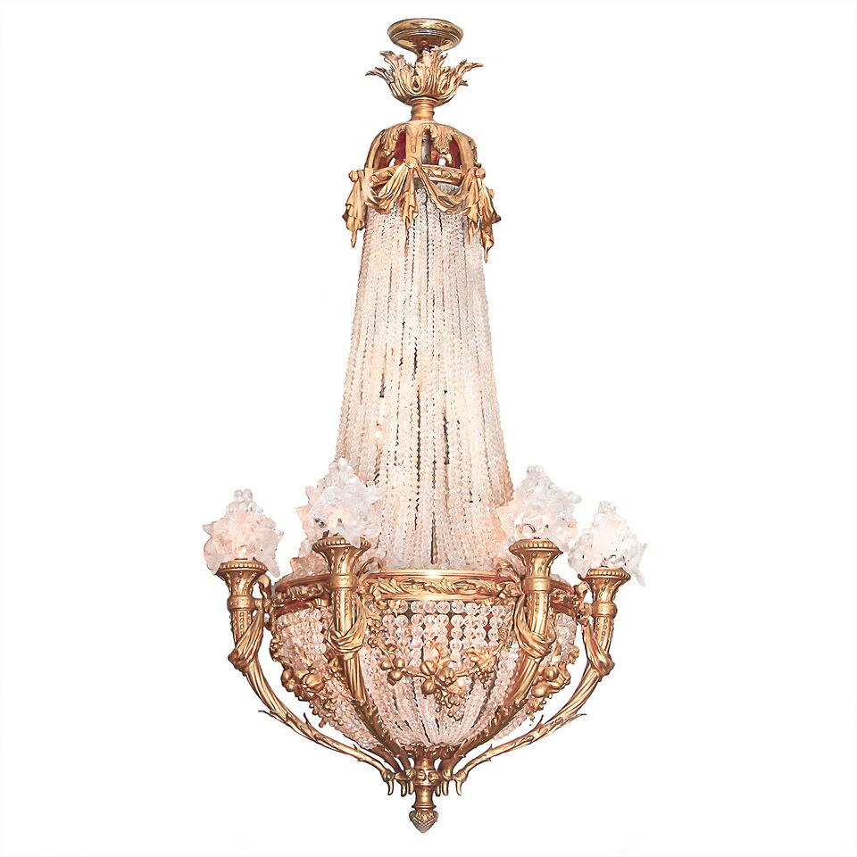Six arms extend from the lower frame of this French Empire Baccarat crystal and heavy bronze chandelier. 