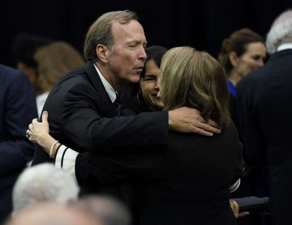 Neil Bush is hugged before  a public celebration of life for Houston Texans owner Robert C. McNair at NRG Stadium. (AP Photo/David J. Phillip, POOL)