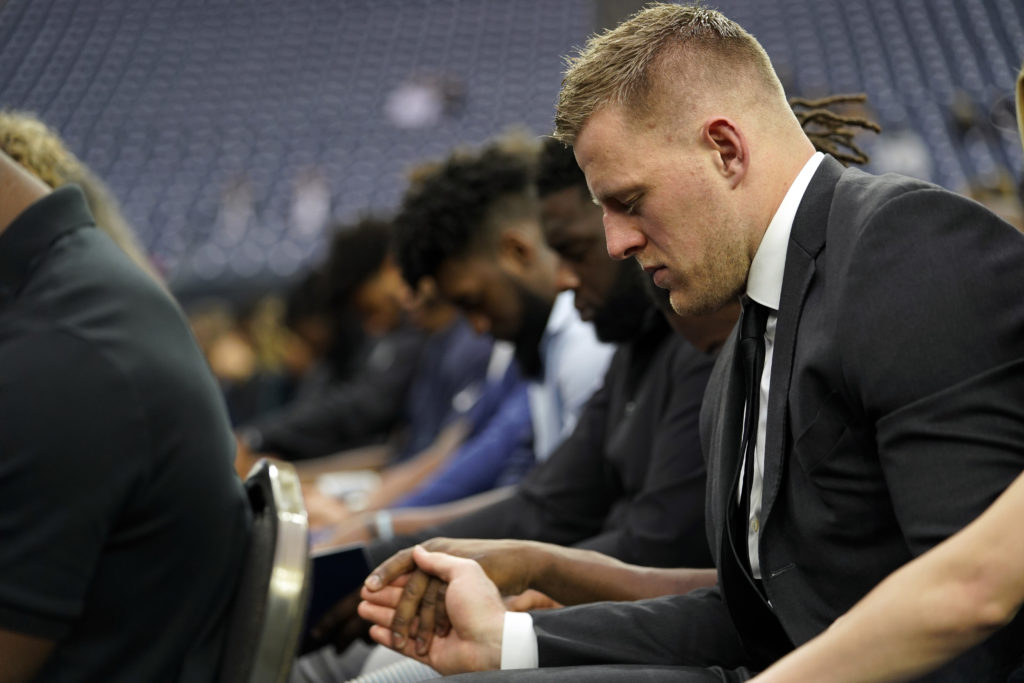 Houston Texans J.J. Watts prays with teammates during a public celebration of life for Houston Texans owner Robert C. McNair at NRG Stadium. (AP Photo/David J. Phillip, Pool)