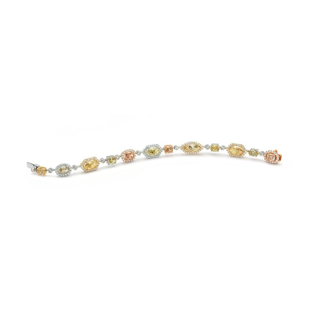 Fancy colored diamonds cut in an array of shapes line this lovely Rosette Bracelet set in white gold.     (1.87 ctw. diamonds and 9.37 ctw. fancy color diamond, price on request)