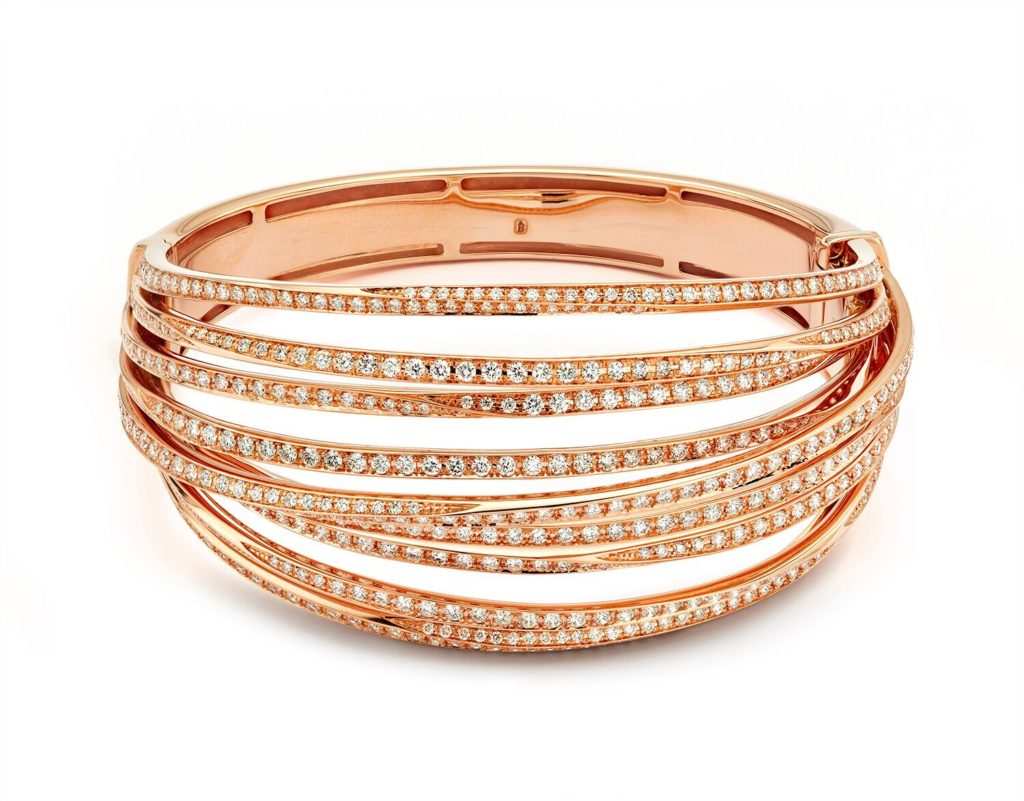 This twisted bangle consists of 9 interwoven bands sprinkled with diamonds in 18K rose gold. (5.81 ctw. diamonds, $28,000)