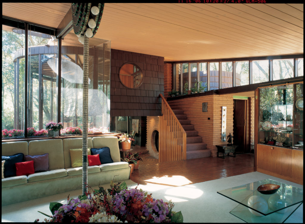 The light-filled front living room of the Durst-Gee House in Houston  maintains an intimate relationship with surrounding nature.