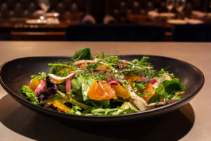 Felix Culpa's winter salad features greens, squash, citrus, pomegranate, radish, pumpkin seeds, and shaved carrots.