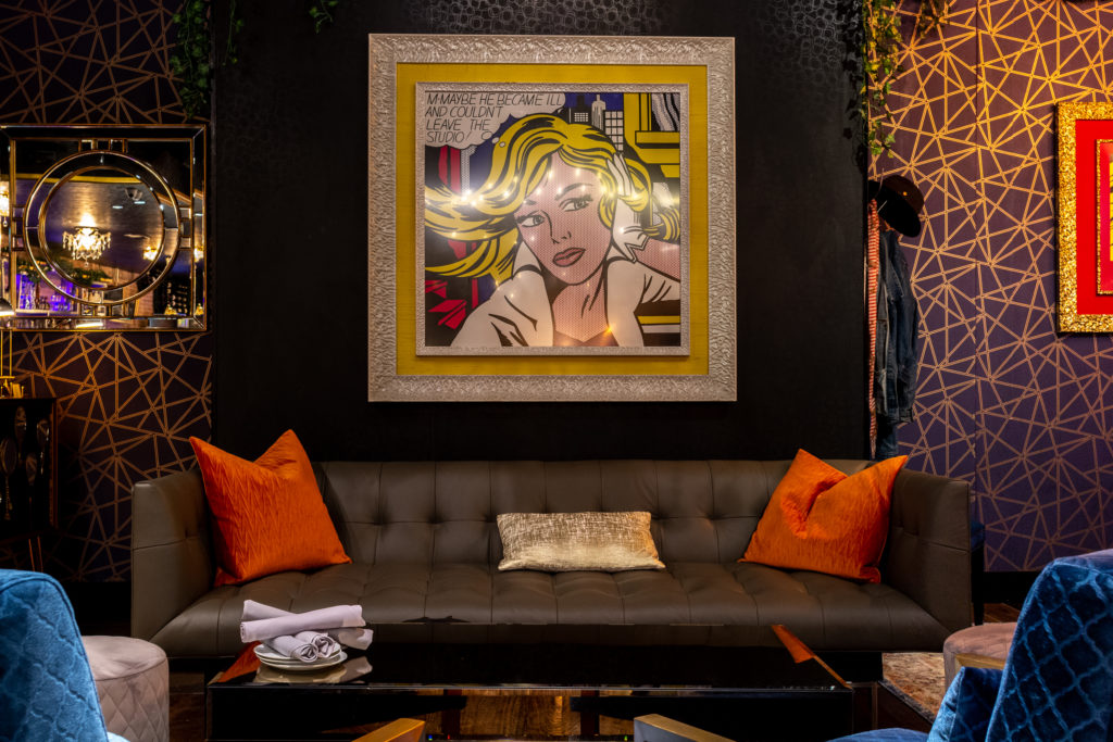 A pop of Pop Art presiding over couch seating