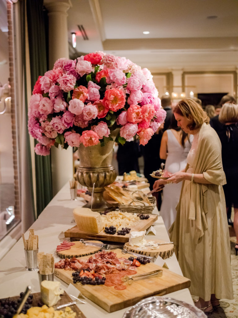A floral arrangement pops at one of the thoughtfully composed food stations (Photo by Liz Banfield)