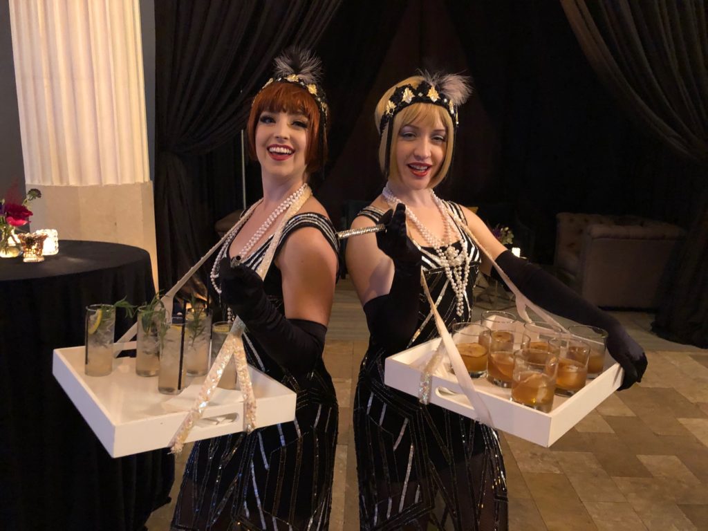 Gin & Tonic and Old Fashioned cocktails are served by '20s era molls.