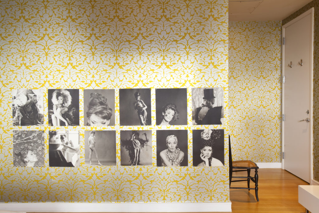 Photographs of burlesque dancers on a wall in the master bedroom. (Photo by Julie Soefer)