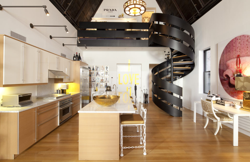 The spiral staircase winds up to the loft area and guest bedroom of the four-story apartment. (Photo by Julie Soefer)