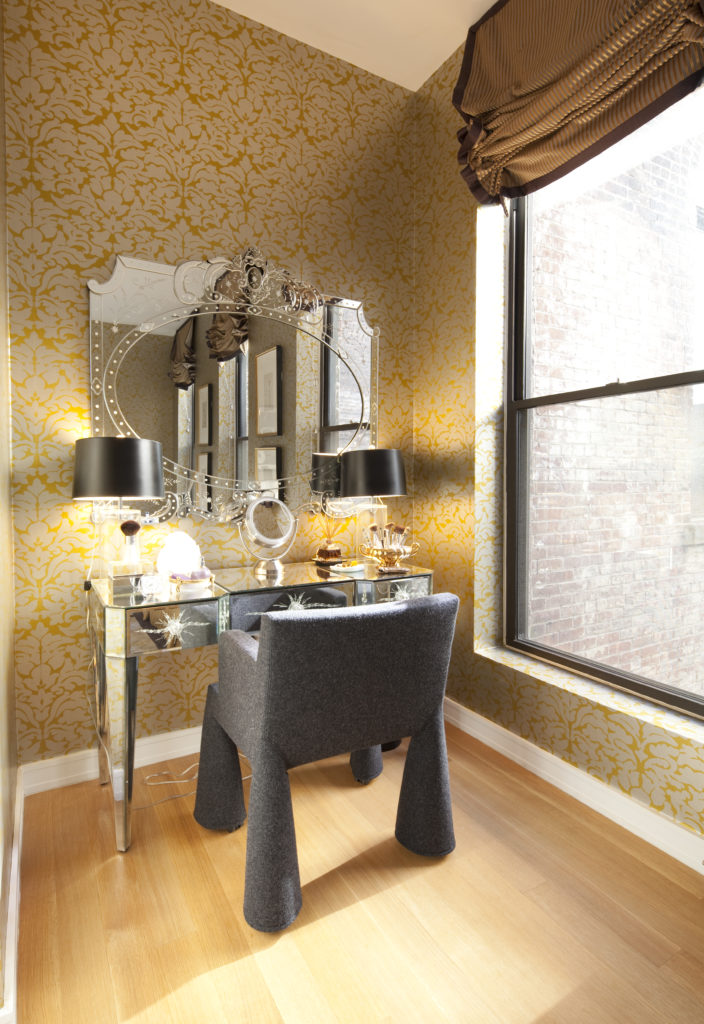 This corner in the master bedroom features a vintage mirrored vanity and a Marcel Wanders V.I.P. chair. (Photo by Julie Soefer)