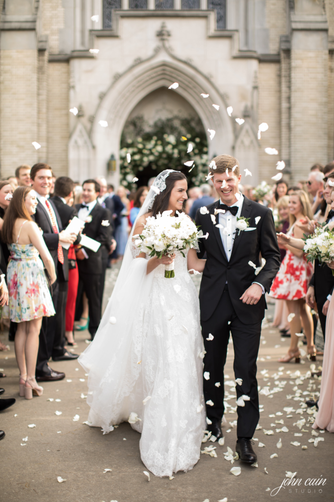 The guests tossed delicate white rose petals on the happy couple. (Photo by John Cain Photography)
