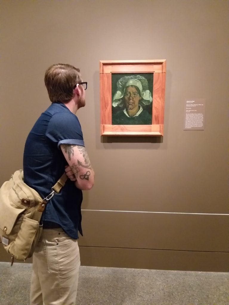 Basking in one of the early works that begins this show. The exhibition is arranged chronologically to reveal Van Gogh, the artist, and his life. Shown: "Head of a Woman Wearing a White Cap," 1884–1885.