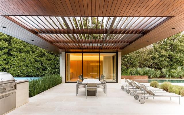 The resort-style cabana has glass doors that open to the grounds. 