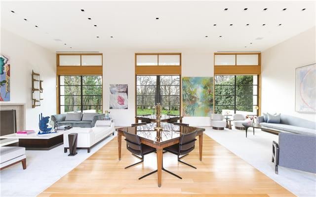 Massive floor-to-ceiling windows bring flair to the well-lit room. 