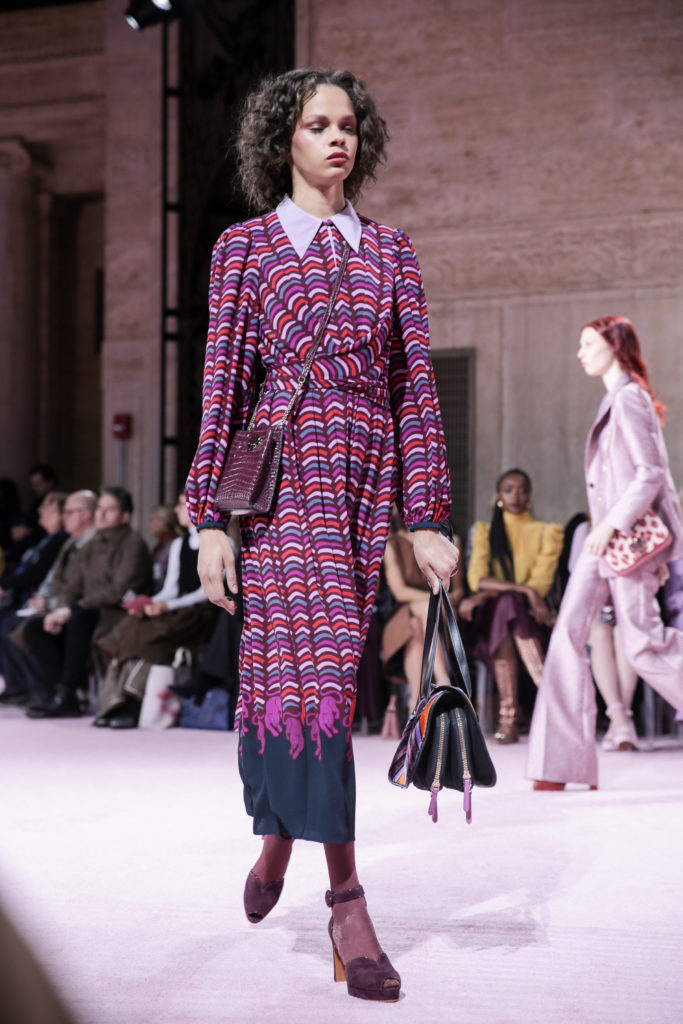 Kate Spade New York multi-color dress, cross-body bad in faux python, and tasseled handbag. (Photo by Kate Spade New York)
