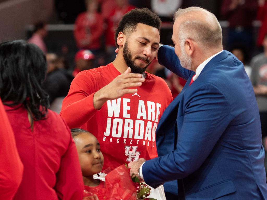 Former UH guard Galen Robinson Jr. shares a moment with athletic director Chris Pezmam. Robinson helped start an NCAA Tournament tradition at UH. (Photo by F. Carter Smith)