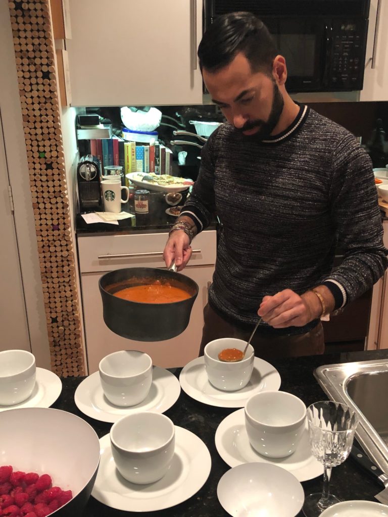 Fady Armanious begins plating his tomato and lentil crab soup. (Photo by Shelby Hodge)