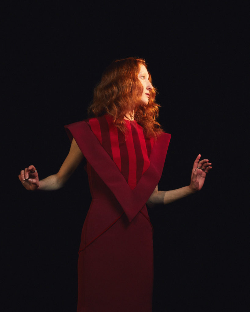 Amir Taghi burgundy dress with inverted striped triangle detail. (Photo by Amir Taghi)