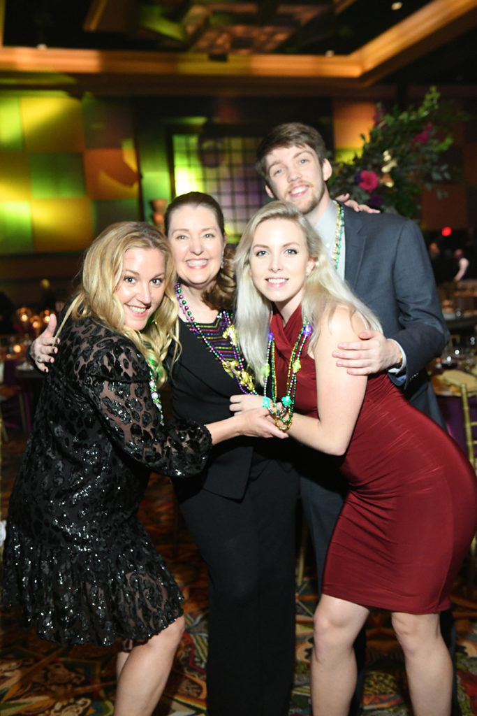 Laurie Davis, Gwen Corrigan, Foster & Tori Harmeye at the University of St. Thomas Mardi Gras ball.