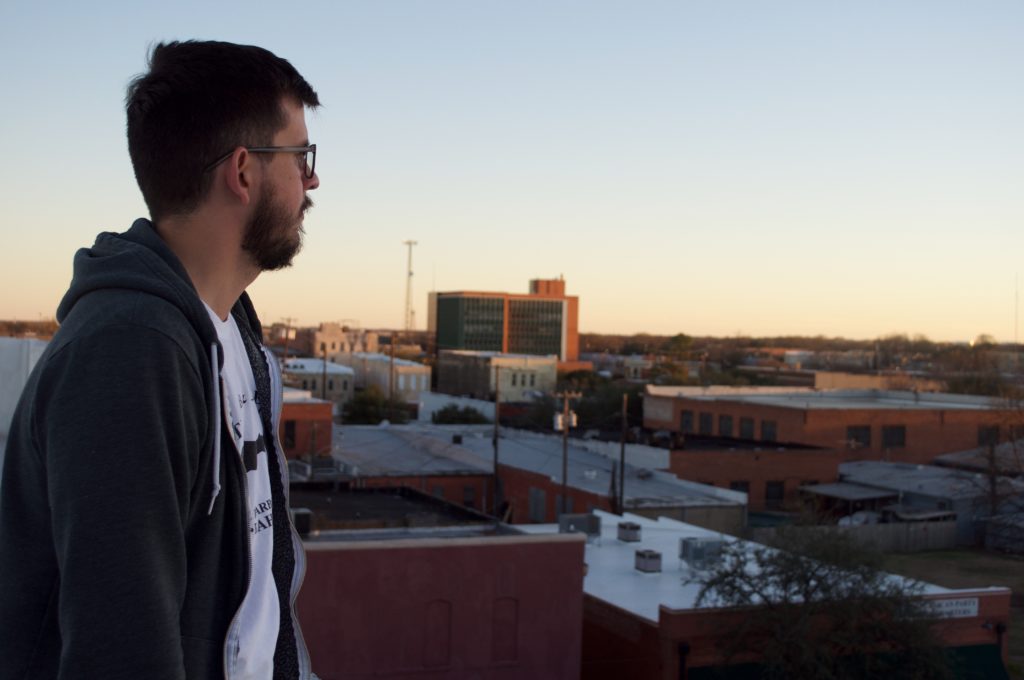 The author on the rooftop of 100 West gazes out upon the metropolis of downtown Corsicana. (Photo by Kyle Hobratschk)