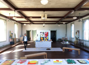 Artist-in-residence Bradley Kerl preparing for open studios at 100 West, Corsicana, Texas. The vast space was originally an Odd Fellows Lodge; the historic building has occupied a prime corner of this Texas hamlet, population 23,000, for 121 years. (Photo by Kyle Hobratschk)