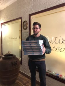 When in Italy: the author transports a tower of Tuscan pizza. (Photo by Lucas Humann)