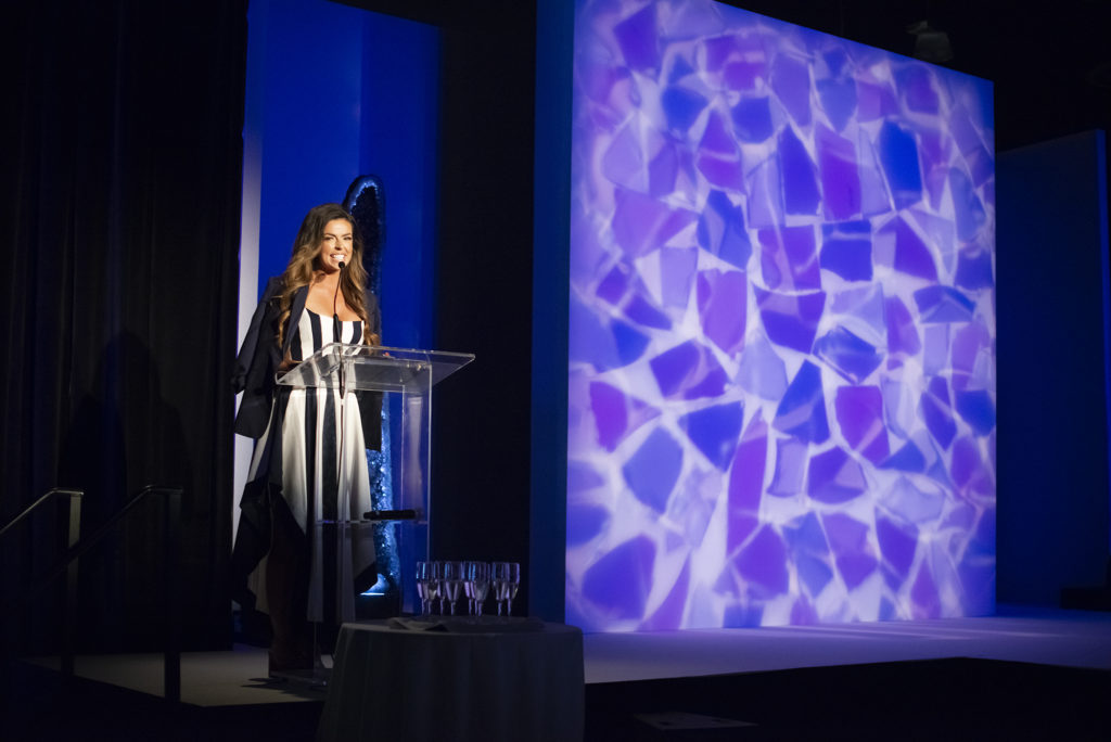 Emcee Logan Lester at the Giving Goes Glam fundraiser at The Woodlands Waterway Marriott. (Photo by Jen McDonald for Interfaith of The Woodlands)