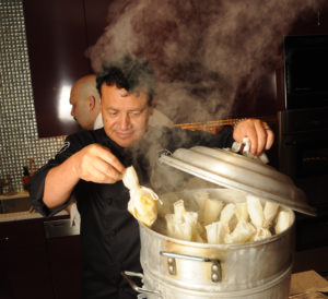 Hugo Ortega cooks for the KNOWAutism dinner in a private home. (Photo by Dave Rossman)