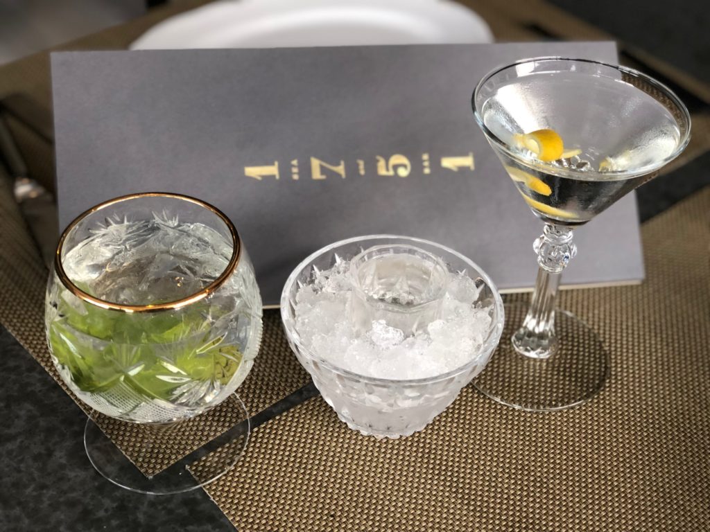 The Clearwater cocktail and the Gin Act martini are among the hundreds of cocktail possibilities at 1751 Sea and Bar. The small glass in the center is the other half of the martini, chilled to perfection. (Photo by Shelby Hodge)