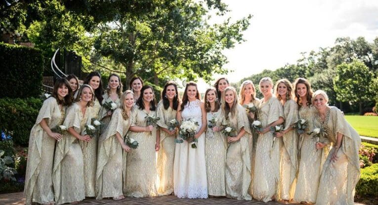 The bridesmaids looked glam in gold caftans.  (Photo by Chris Bailey )