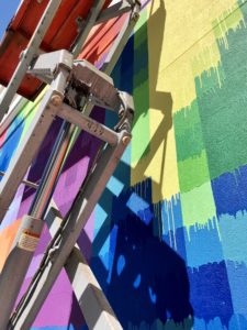 “Pearl Paint Wall” in process, showing the pixelated grids that form five portraits representing the construction trade in Houston. Houston-headquartered developer Morgan commissioned the public artwork for its new Pearl Marketplace at Midtown.